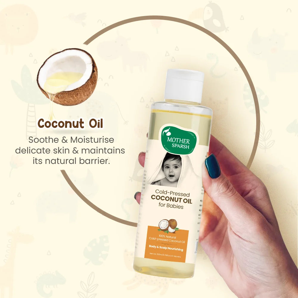 Hand holding Mother Sparsh Cold-Pressed Coconut Oil for Babies, which soothes and moisturizes delicate baby skin and maintains its natural barrier.